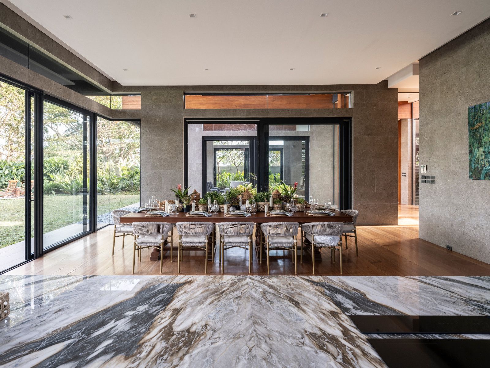 A beautifully-set tropical tablescape in a Batangas, Philippines home designed by LYS Architecture, punctuated by greenery