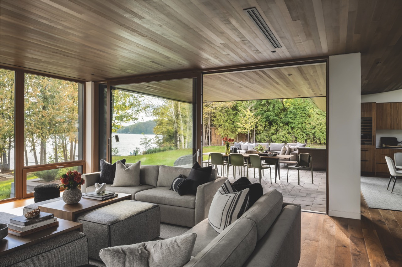 The patio extends the living space outdoors with dining and seating areas overlooking the lake