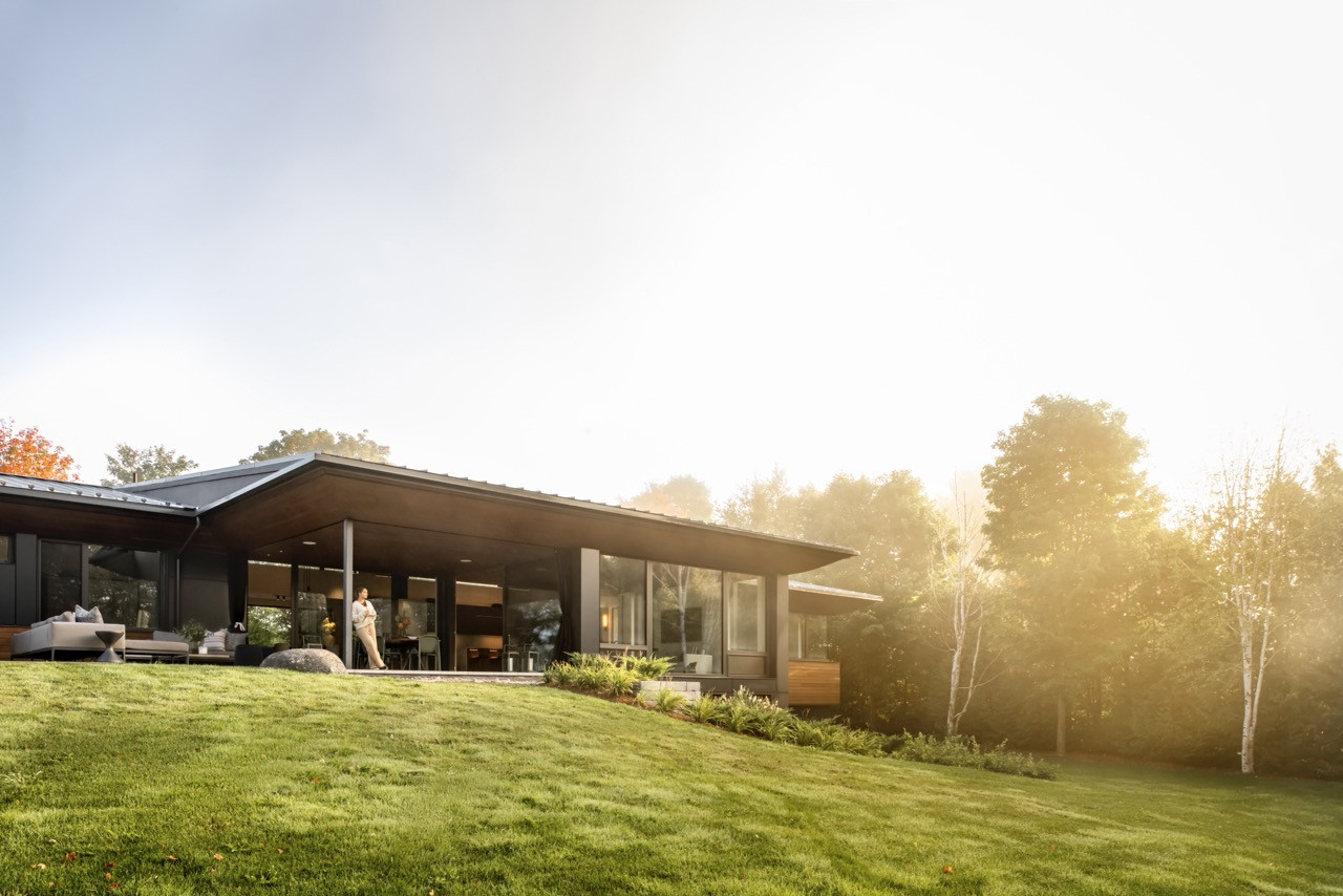 Clean horizontal lines and expansive windows connect the 6,578 sq ft residence to its lakeside setting beautifully