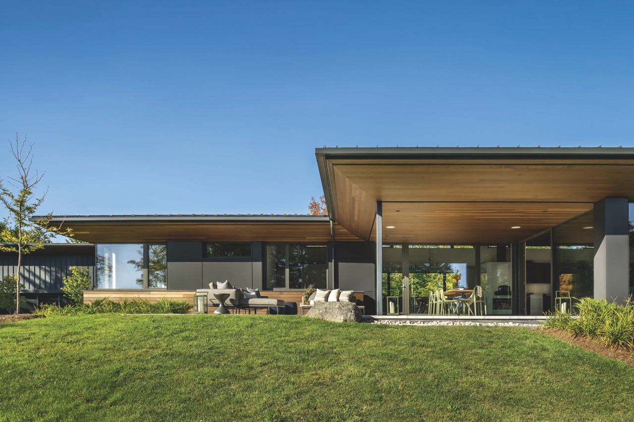 Large overhangs and angular rooflines denote the house’s exterior, which combines metal, stone and wood