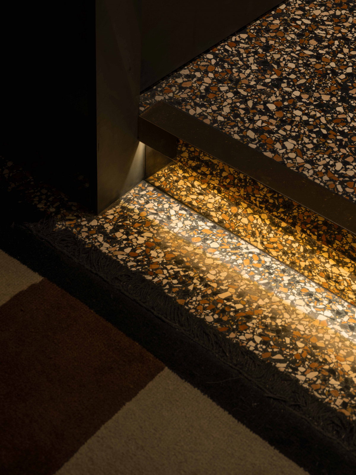 A polished terrazzo-floored corridor leads clients to private VIP rooms