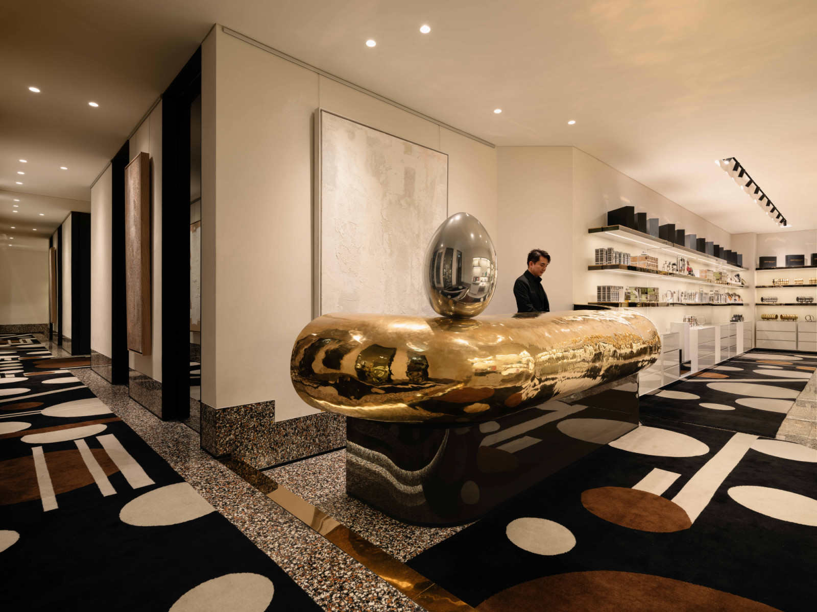 The sculptural solid brass reception counter was handcrafted in Thailand and flown into Singapore in one complete piece