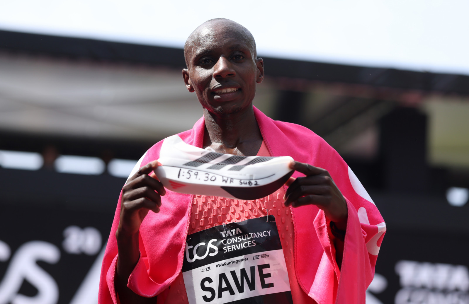 LONDON, ENGLAND - APRIL 26: Sabastian Sawe of Team Kenya celebrates with his adidas shoe after winning with a new World Record time during the Men’s 2026 TCS London Marathon on April 26, 2026 in London, England. (Photo by Alex Davidson/Getty Images)