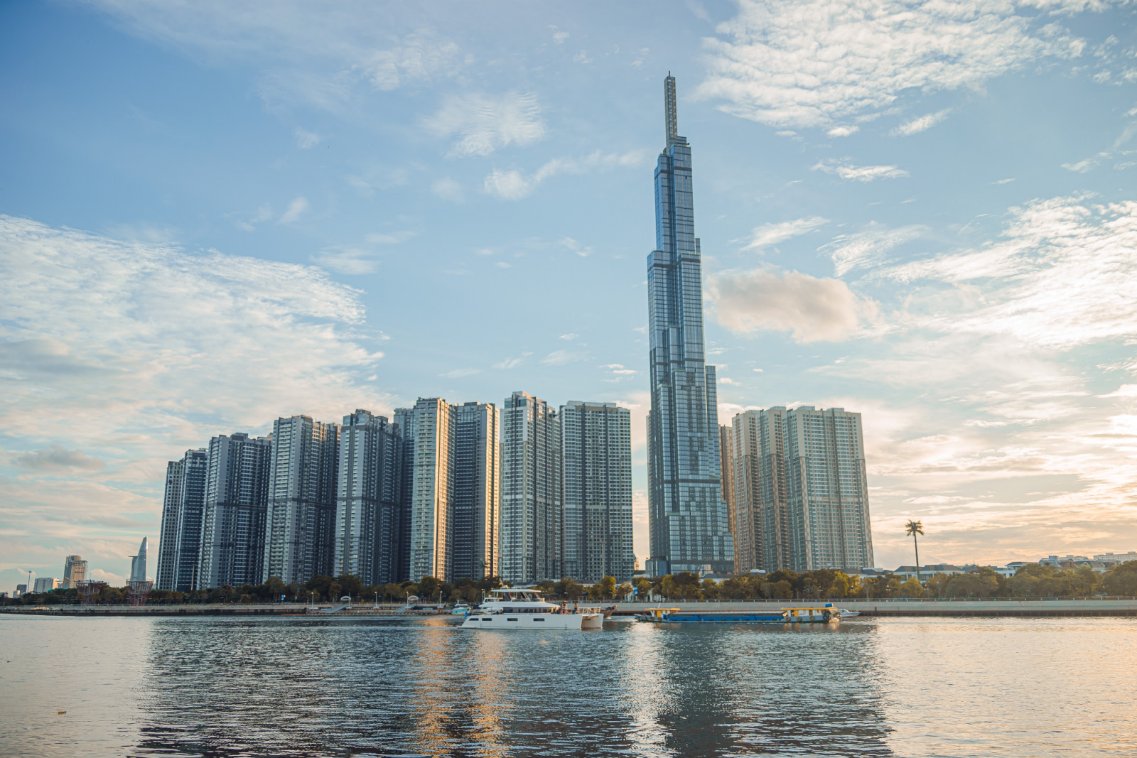 Beautiful blue sky view at Landmark 81 is a super tall skyscraper in center Ho Chi Minh City, Vietnam and Saigon bridge with development buildings, energy power infrastructure. Finance and business concept.