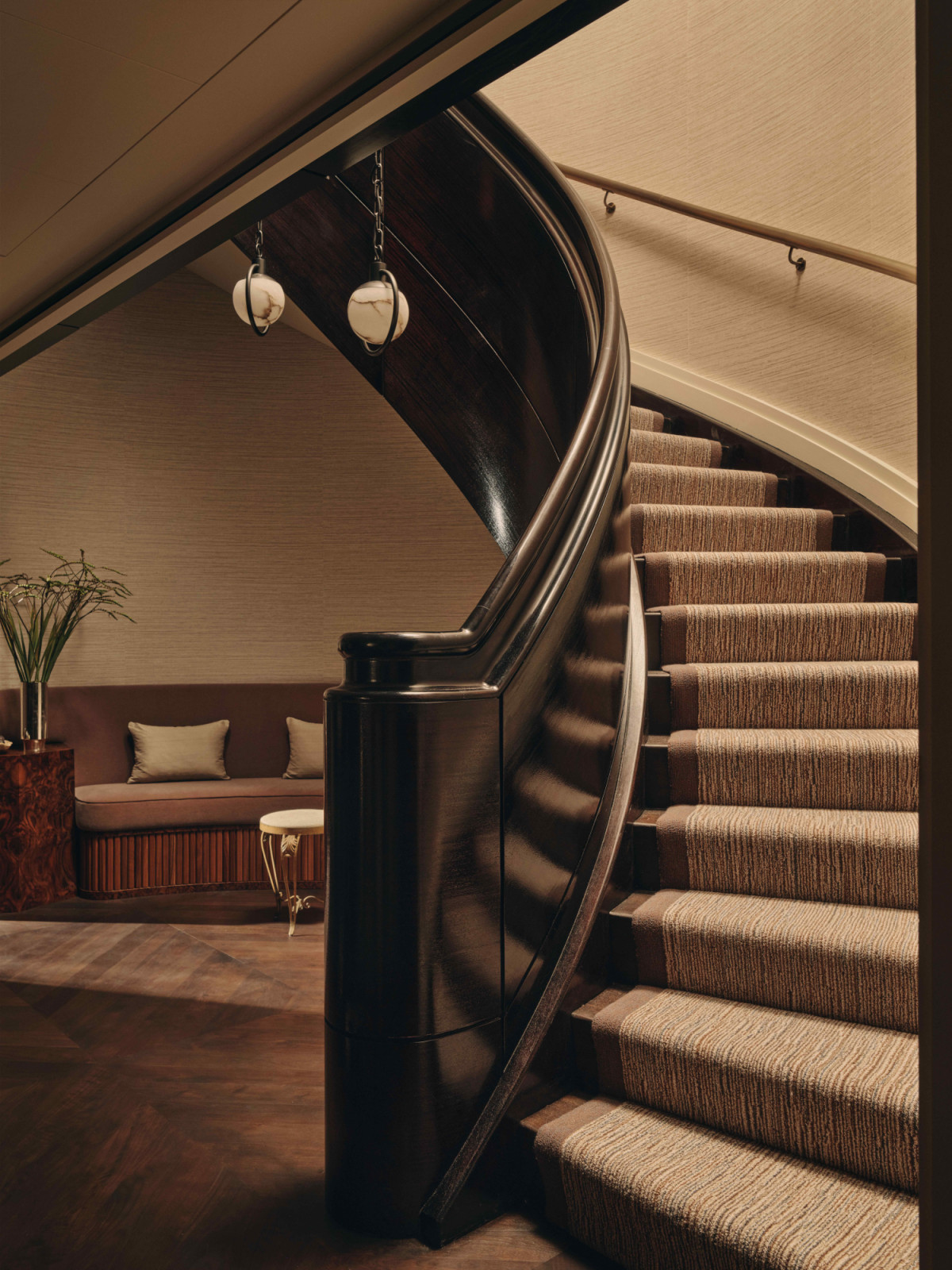 The Art Deco influences of the original build remain present, restrained with warmth through softer tones and organic, curved forms