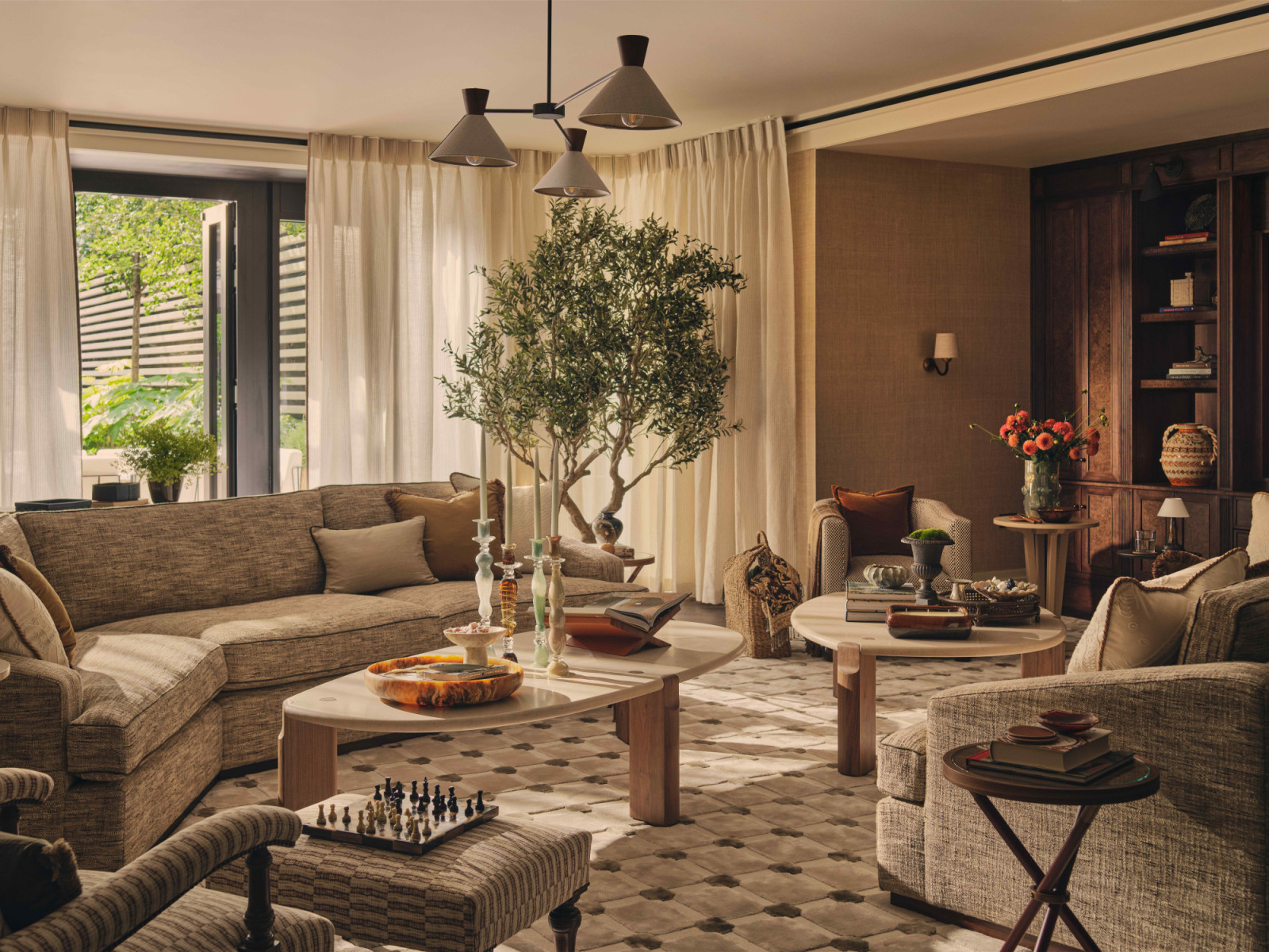 The main living room anchored by a palette of warm neutrals enriched with accent tones