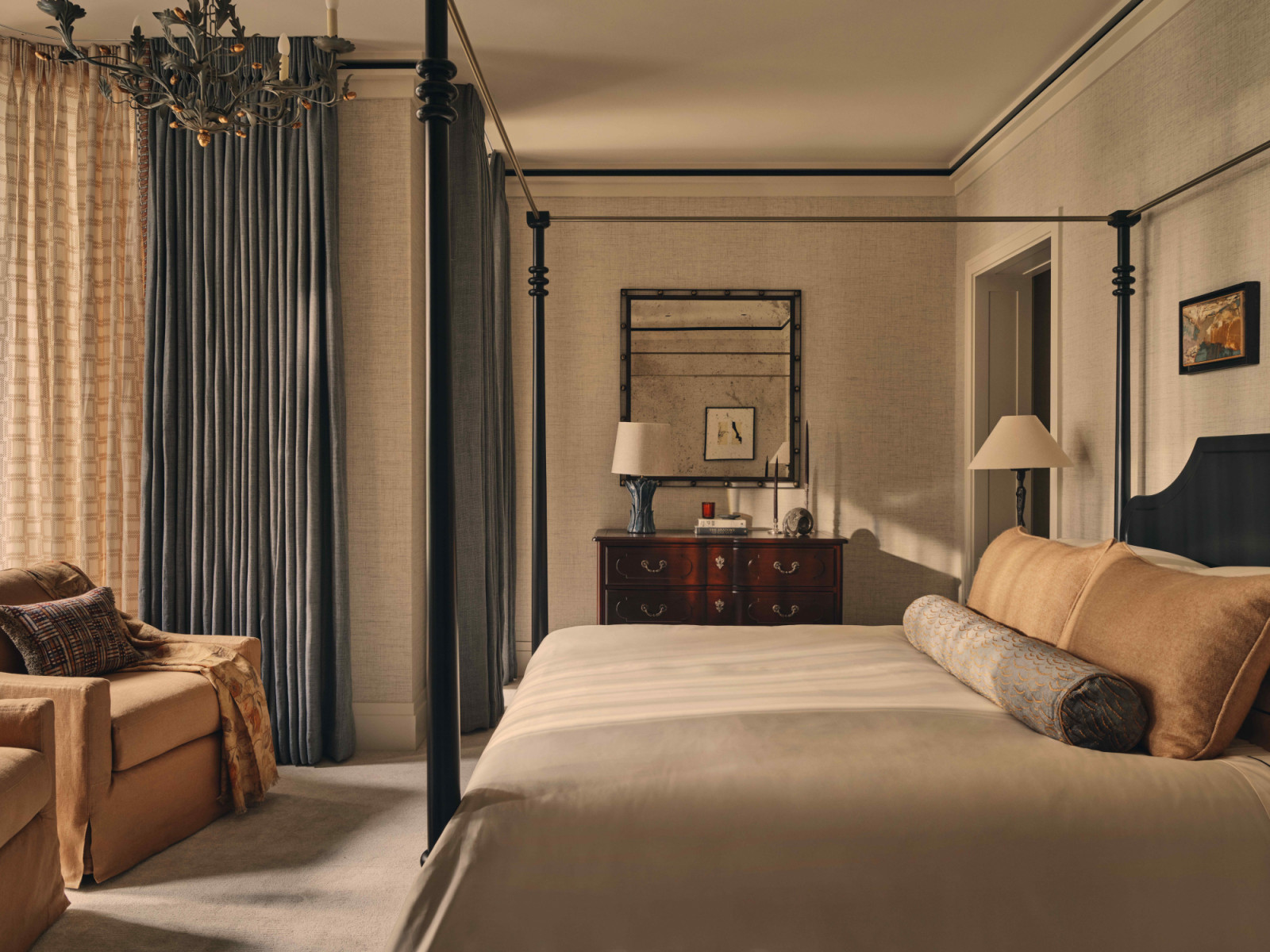 The main bedroom with warm, richly toned bed linens enhancing a sense of intimacy
