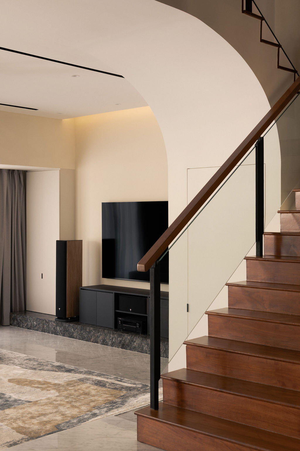 An archway marks the transition to the staircase