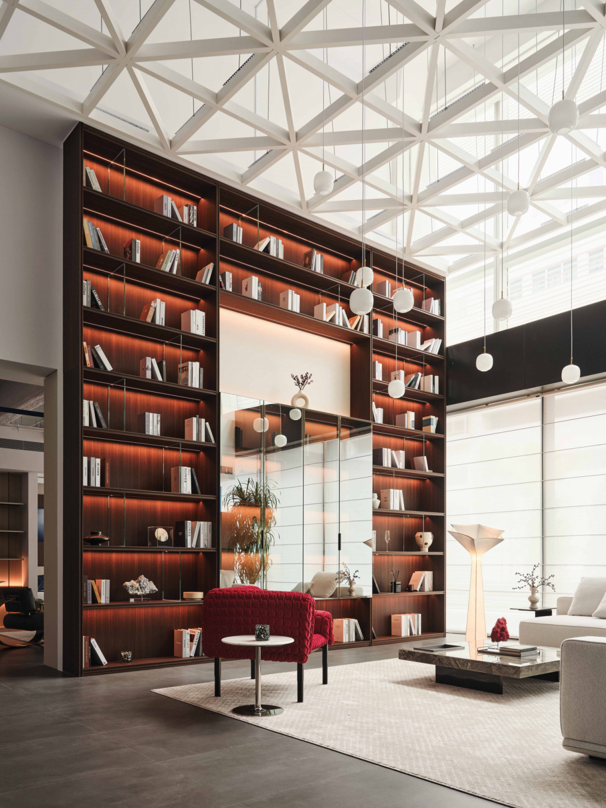The Mretty Singapore showroom features a meticulously lit double-height display cabinet that anchors and frames the space