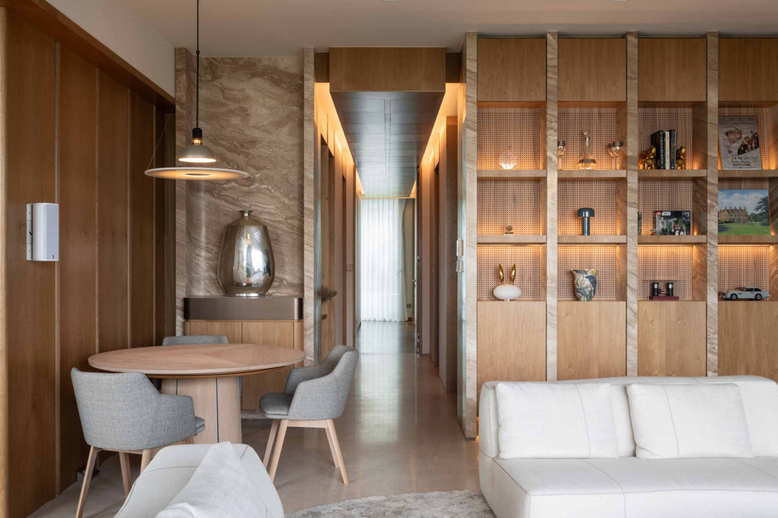 This unique shelving unit in the living room screens off the dry kitchen from view
