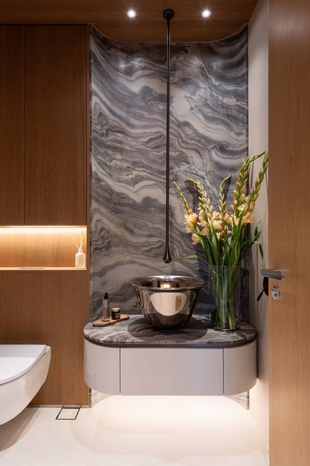 The unusual Gessi Goccia spout descends from the ceiling