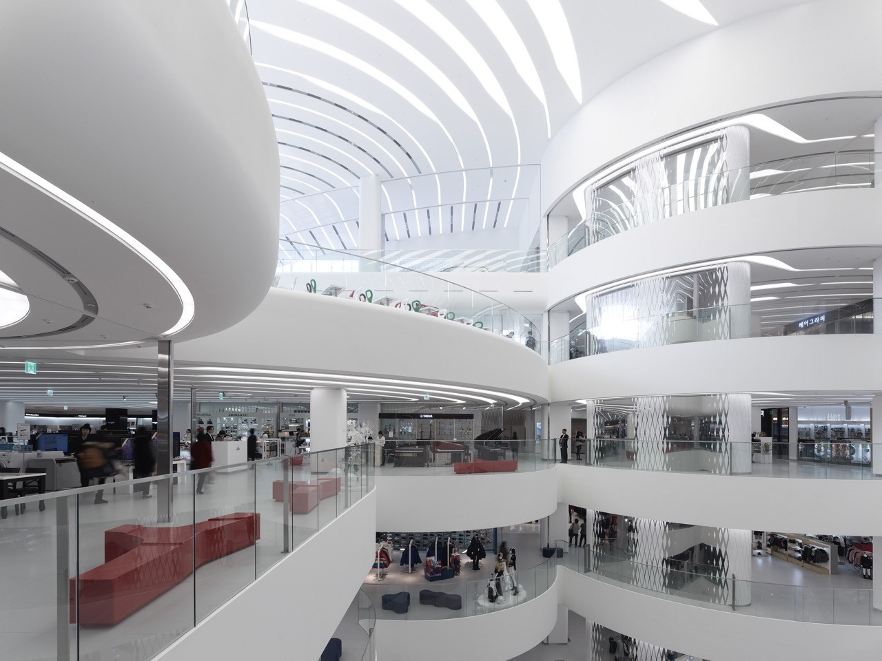 The multi-level interior atrium of Galleria Centercity, Cheonan, featuring UNStudio’s sequence of curved white platforms designed to recast the department store as a cultural as well as a commercial destination (Photo: Getty)