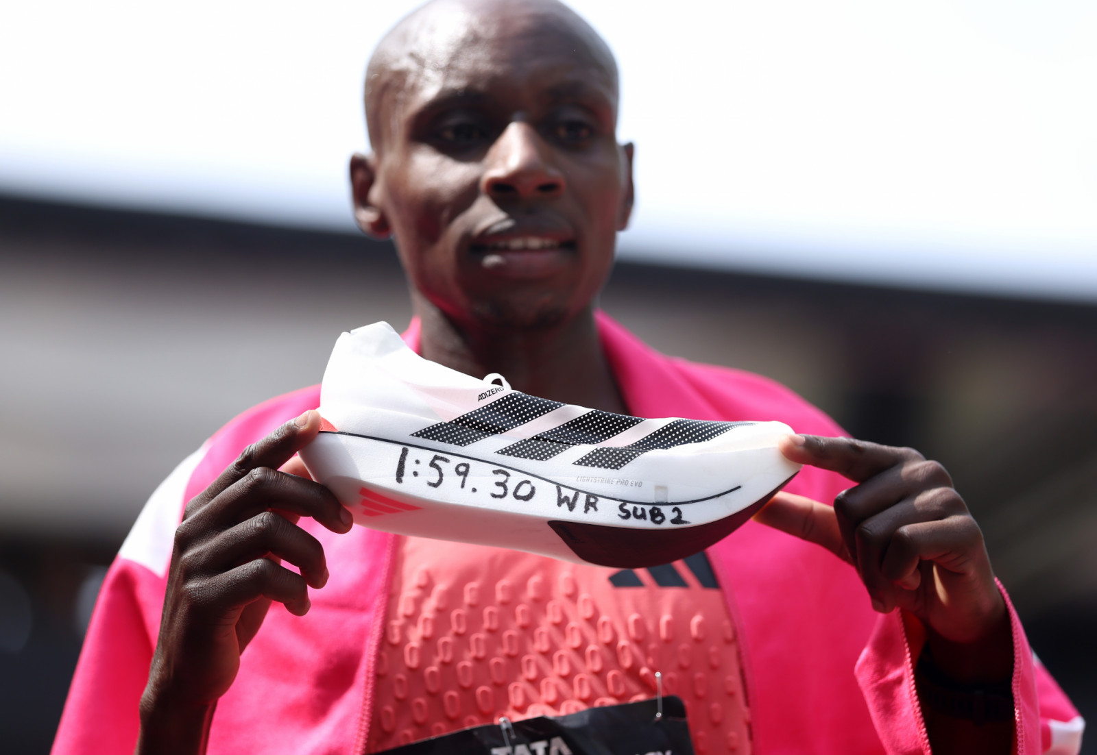 LONDON, ENGLAND - APRIL 26: Sabastian Sawe of Team Kenya celebrates with his adidas shoe after winning with a new World Record time during the Men’s 2026 TCS London Marathon on April 26, 2026 in London, England. (Photo by Alex Davidson/Getty Images)