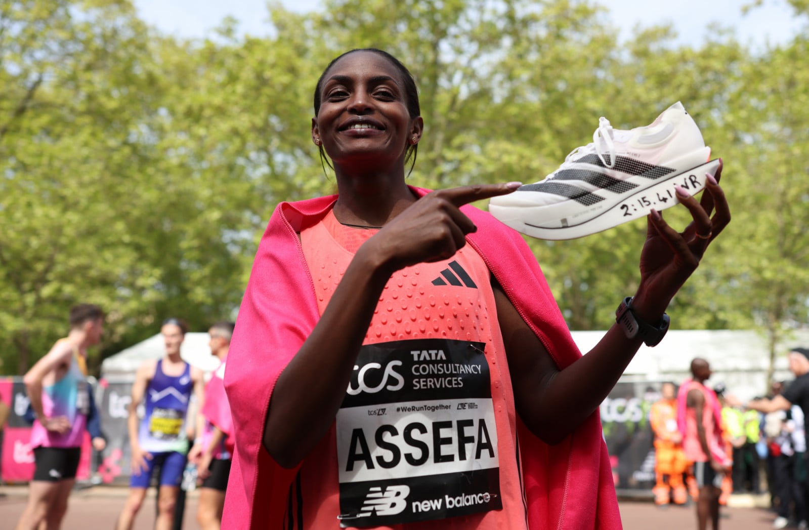 LONDON, ENGLAND - APRIL 26: Tigst Assefa of Team Ethiopia celebrates with her adidas shoe after winning with a new World Record time during the Women’s 2026 TCS London Marathon on April 26, 2026 in London, England. (Photo by Alex Davidson/Getty Images)
