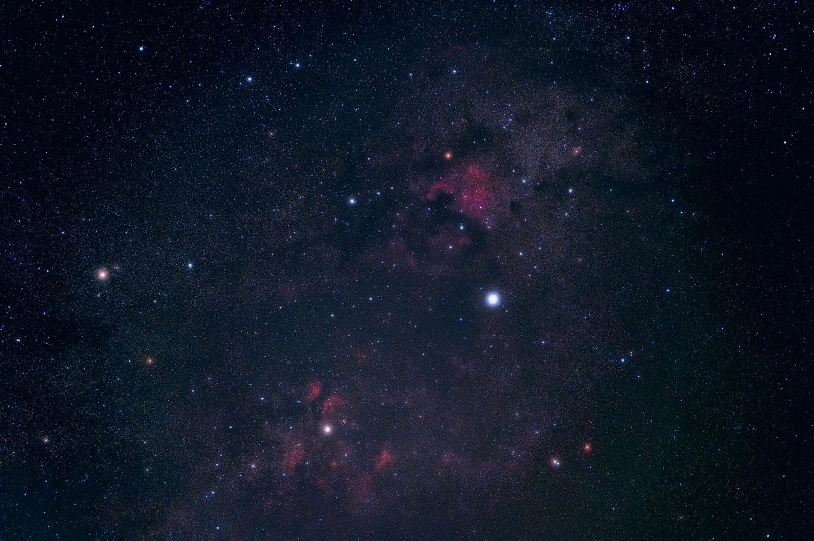 Deep sky image of Cygnus area including the bright alpha star Deneb and famous deep sky objects such as North America Nebula, Pelican Nebula and Butterfly Nebula.