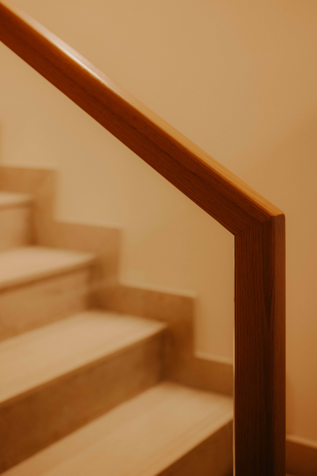 A timber handrail follows the staircase in this West Coast home