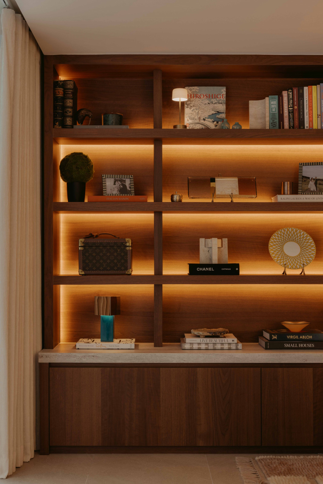 The couple’s interests are displayed around throughout the house, such as Hermès home décor pieces, and books on cooking and design