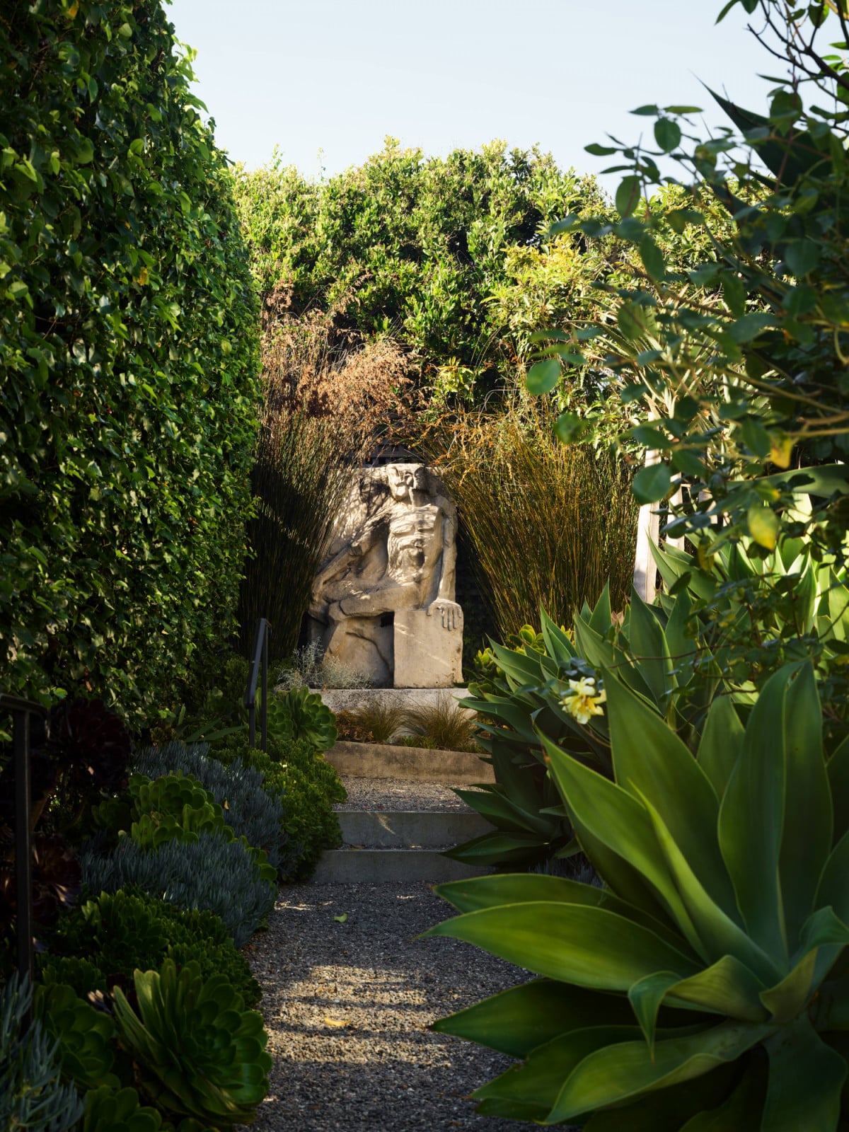 Rather than driving directly up to the residence, visitors must walk along a nature-lined path