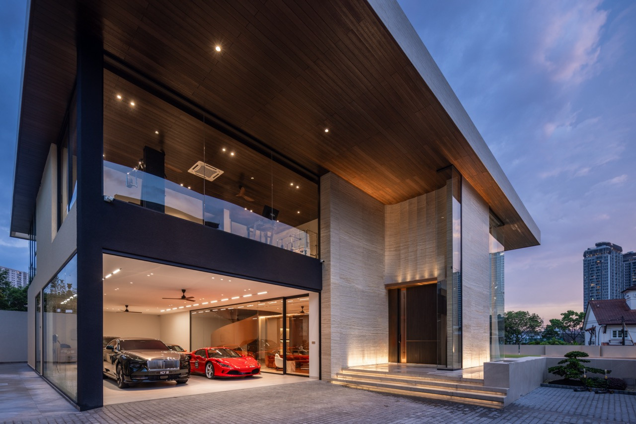 The car lounge, glazed on the driveway side, with the travertine entrance tower and pivot door to the right