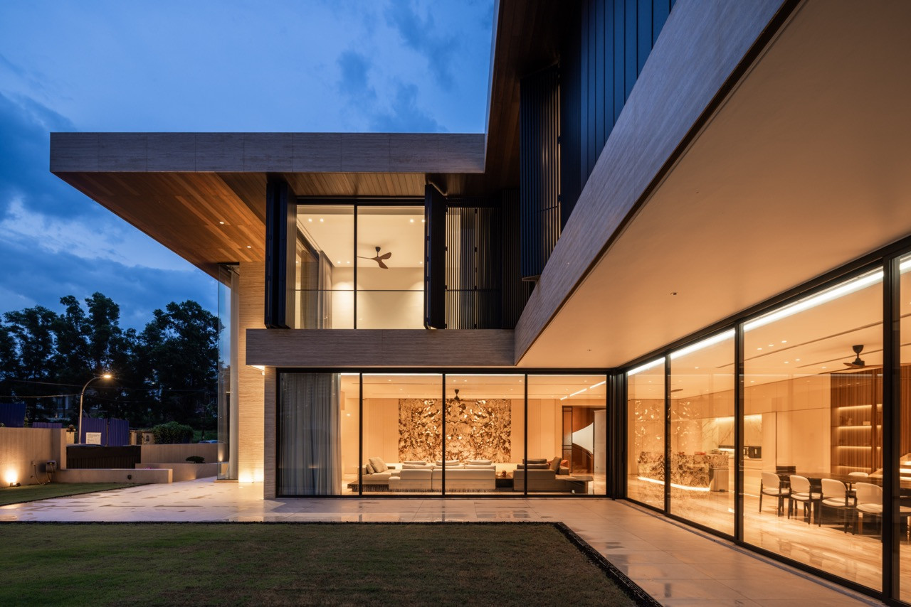 The lawn-facing elevation, with full-height sliding glass doors running the width of the ground floor