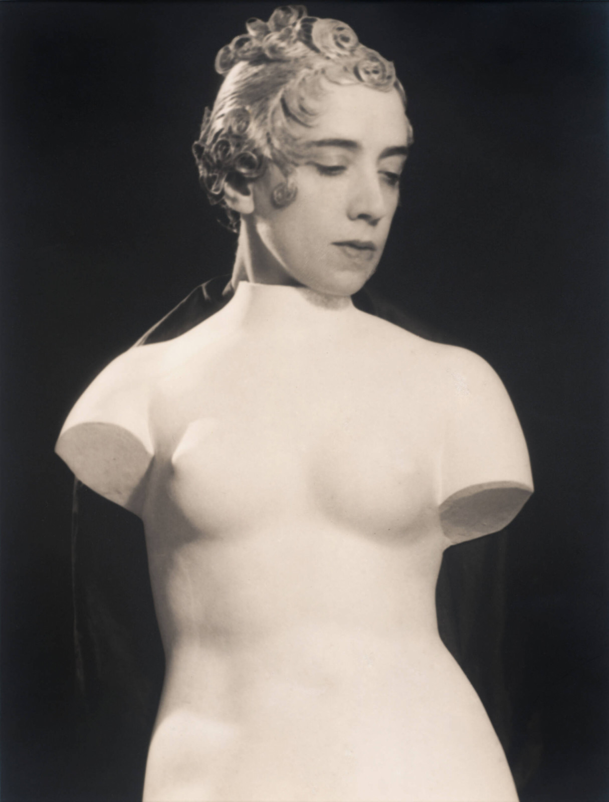 A portrait of Elsa Schiaparelli, photographed by Man Ray. Photo: Courtesy V&A / 2025 Man Ray 2015 Trust. DACS, London. Photo Collection SFMOMA. The Helen Crocker Russell and William H. and Ethel W. Crocker Family Funds purchase