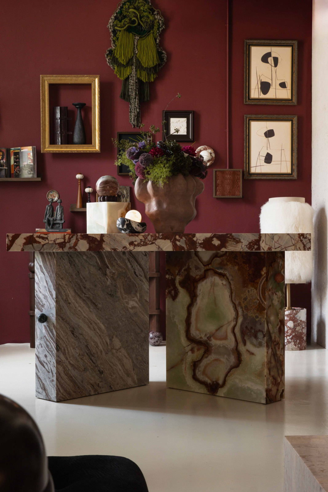 Dialogue Table, crafted from mixed marble, stands taller than a traditional dining table to encourage movement, mingling and exchange
