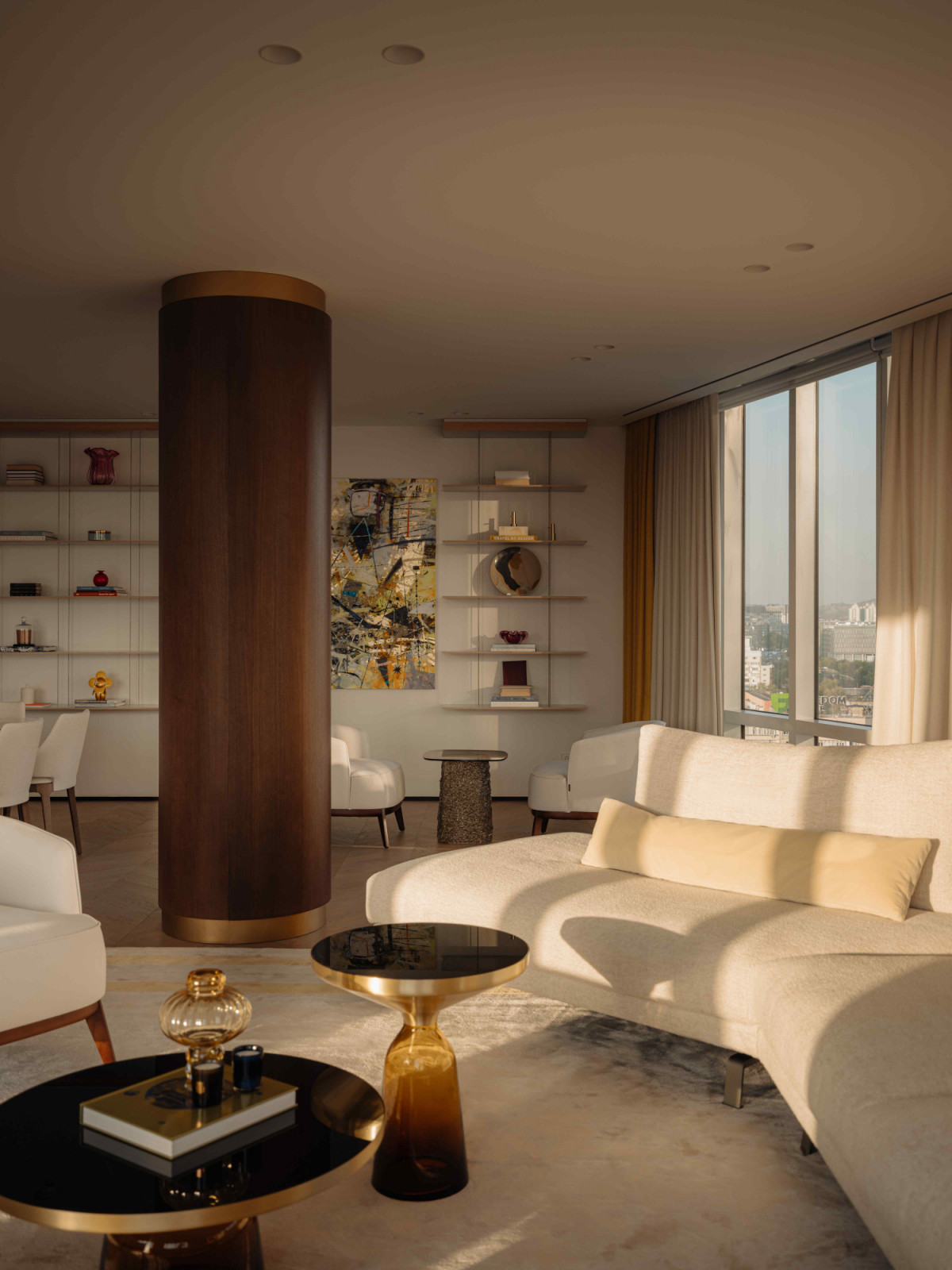 The large column with veneered detailing serves as a subtle spatial divider in the living area