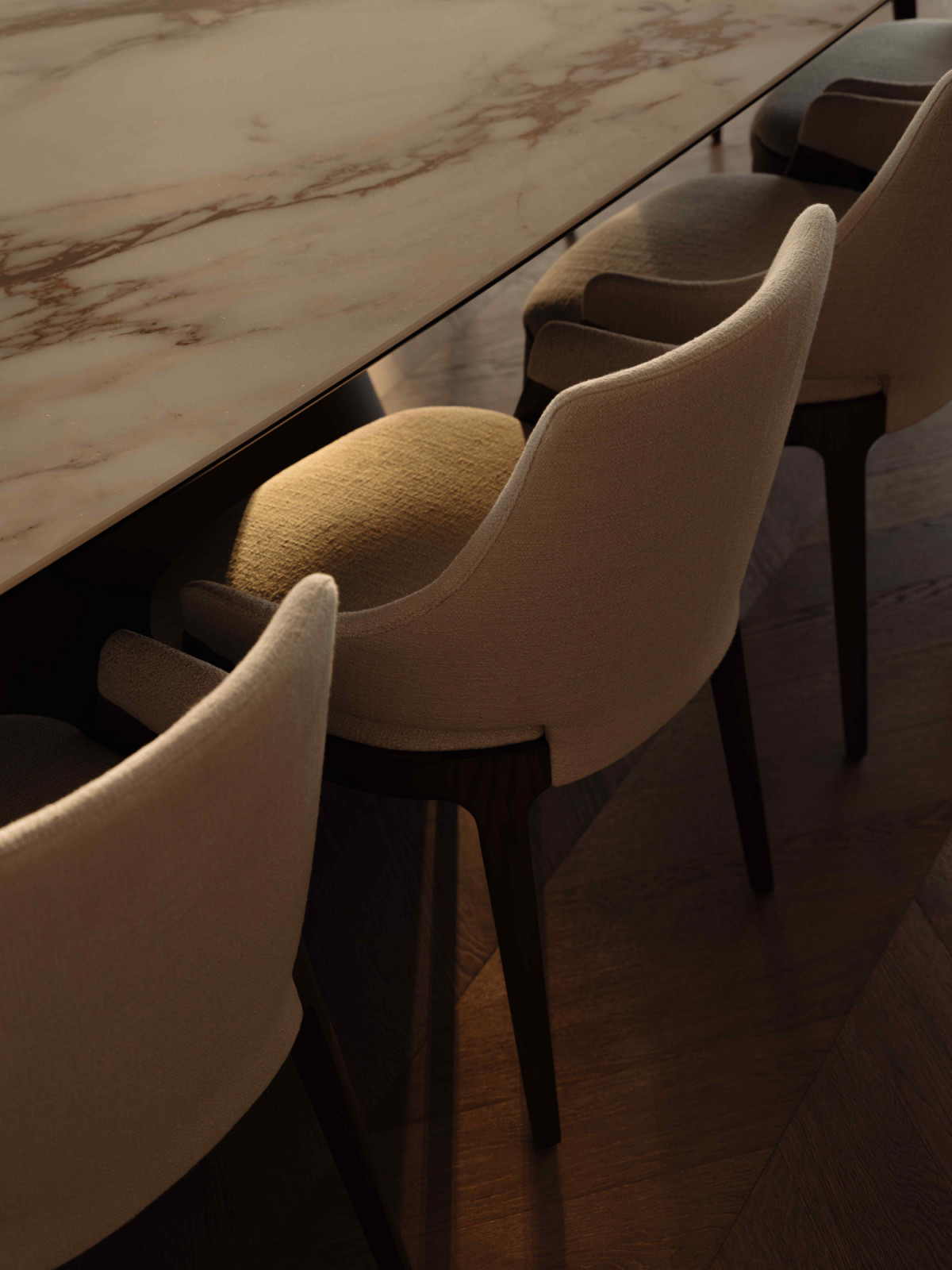 The custom-designed dining table topped with Cattelan Italia marble and Potocco dining chairs