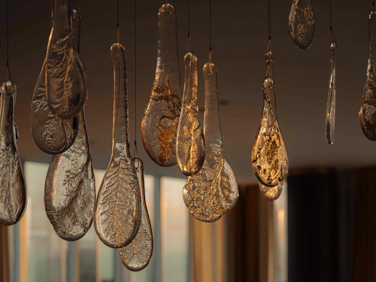The intricate floral motifs of the bespoke Herbarium lighting installation by Lasvit