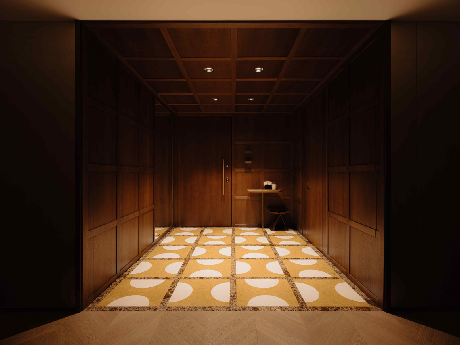 Wood-panelled walls and ceilings, and patterned flooring with yellow accents in the entryway