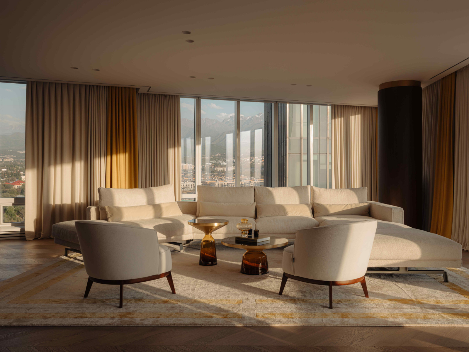 In the living room, subtle pops of yellow soften the starkness of the glass, allowing the sunlight to filter through
