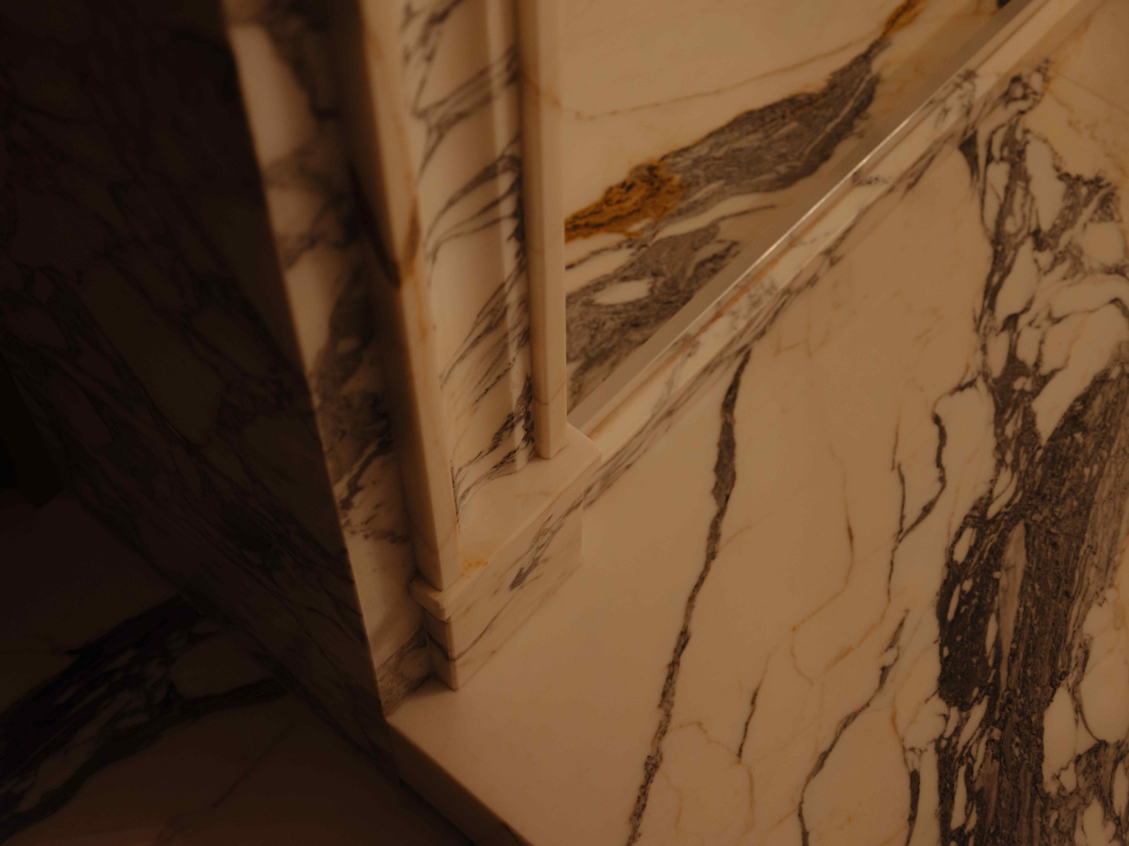 The natural stone creates a grounded, tranquil atmosphere in the spa-like bathroom