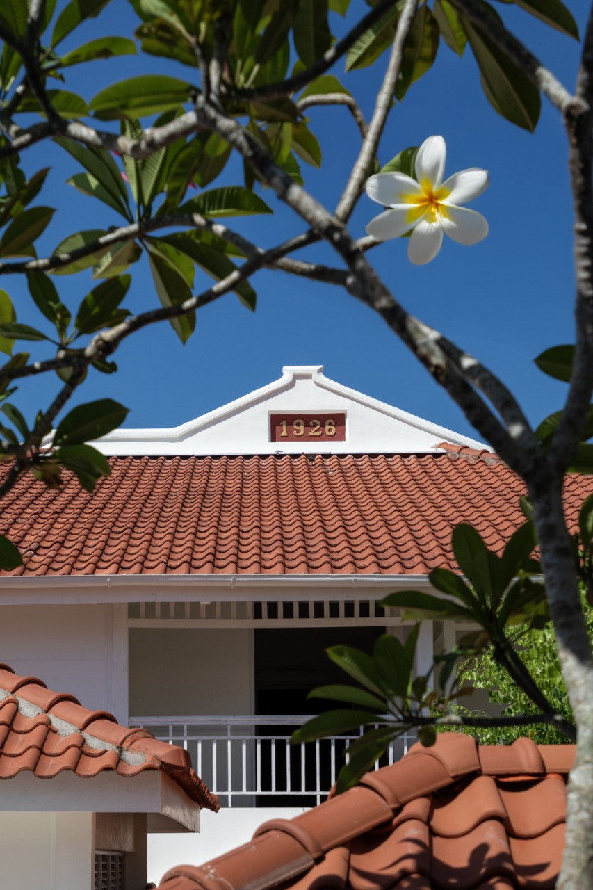 The original date marker on the gabled pediment, with terracotta roof tiles below