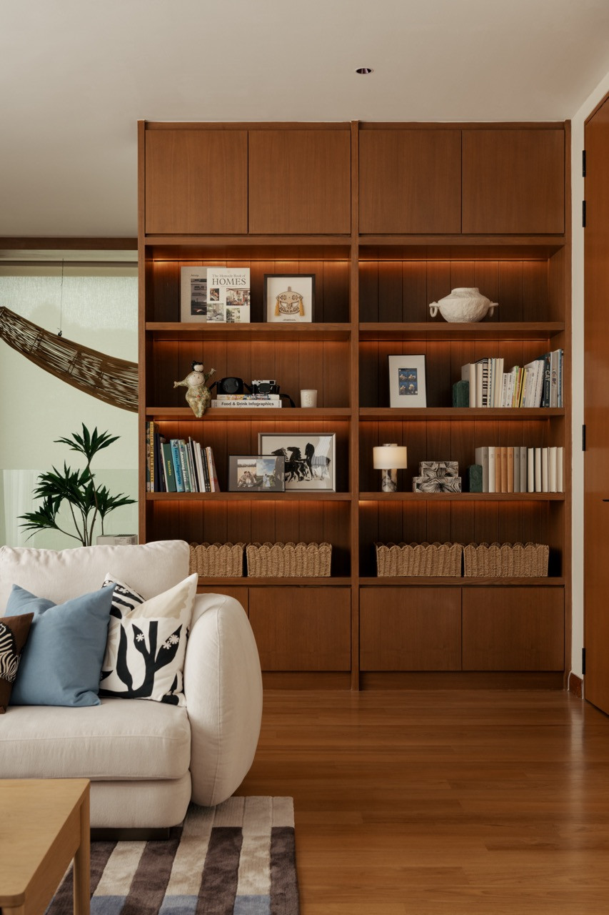 The entertainment lounge on the first floor features full-height timber shelving with integrated cabinetry