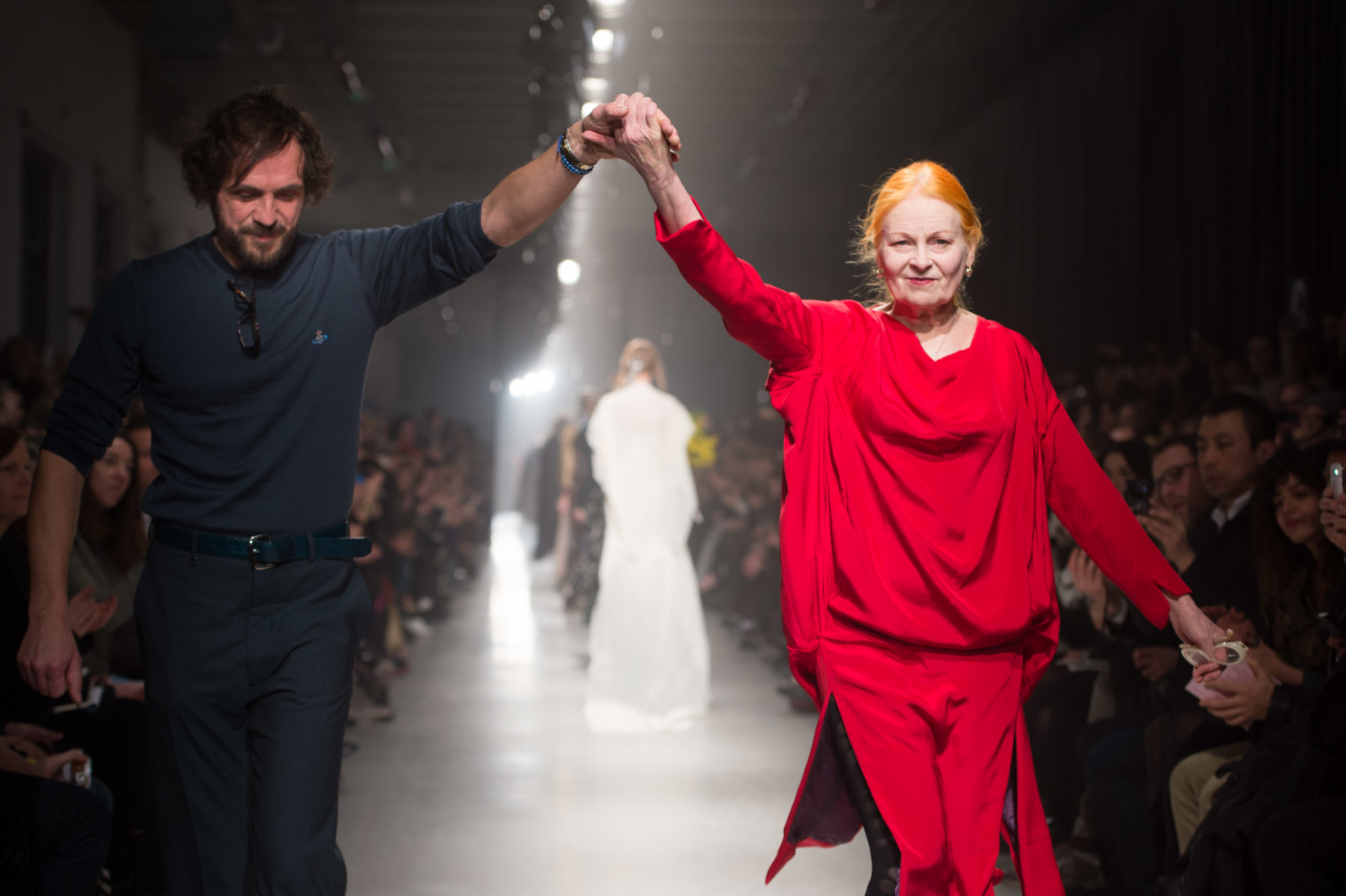 Fashion designer Vivienne Westwood (R) and Andreas Kronthaler acknowledge applause following the Vivienne Westwood's Fall/Winter 2013/14 Ready-to-Wear show as part of Paris Fashion Week, in Paris (Photo by Stephane Cardinale/Corbis via Getty Images)