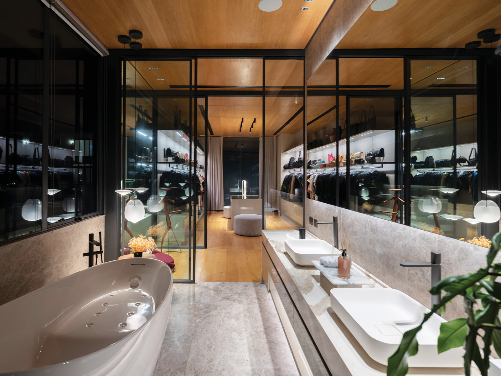 The ensuite features his-and-hers vanity basins, a bath tub and a bit forward, the walk-in closet