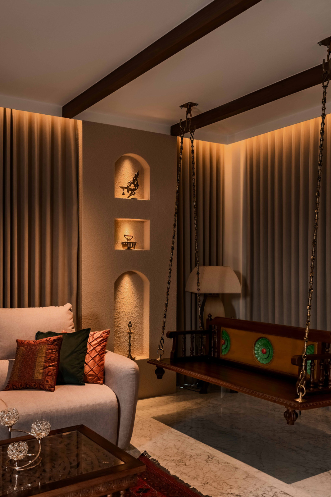 A carved wooden swing sits in this cosy living room