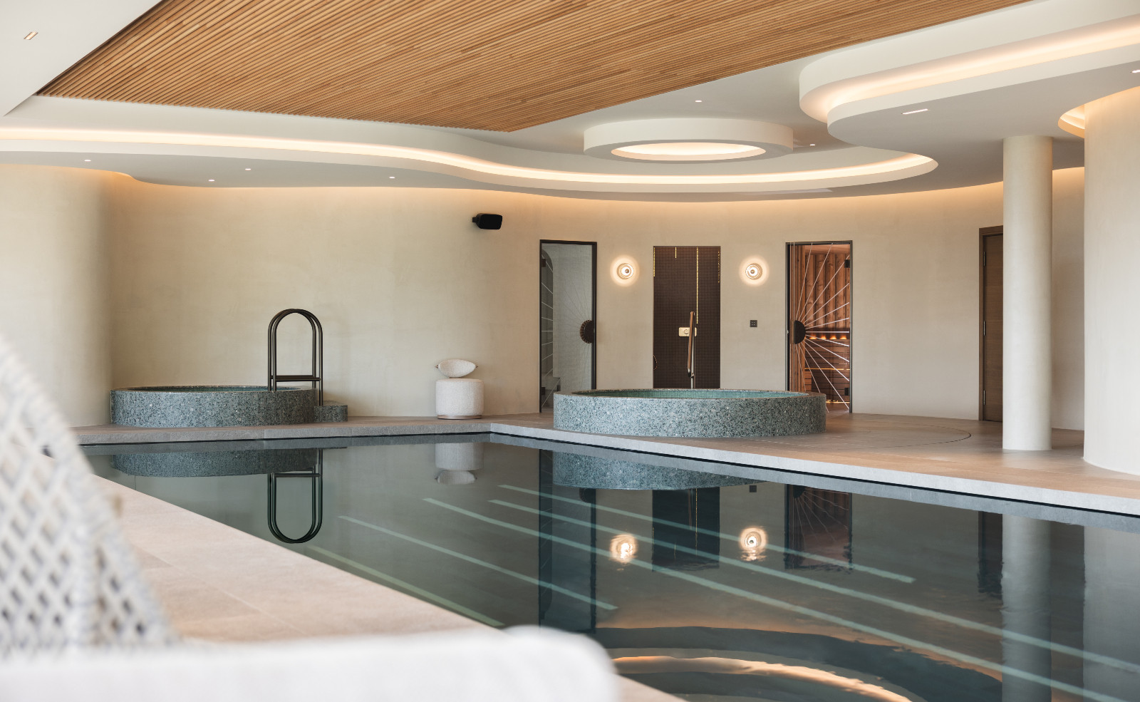 The indoor pool in a multigenerational family chalet in the Swiss Alps designed by Portia Fox Interiors