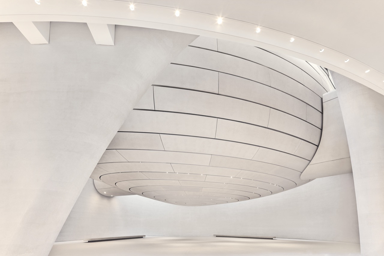 A curved gallery interior at the Zayed National Museum, with its layered ceiling and sweeping white walls designed by Foster + Partners