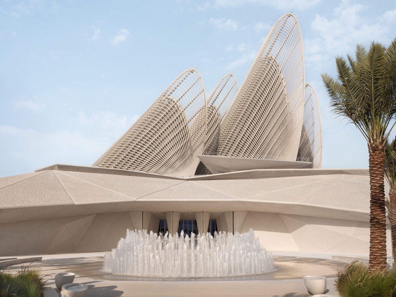 The exterior of the Zayed National Museum in Abu Dhabi's Saadiyat Cultural District, with all five falcon-wing towers visible above the sandstone-toned entrance facade