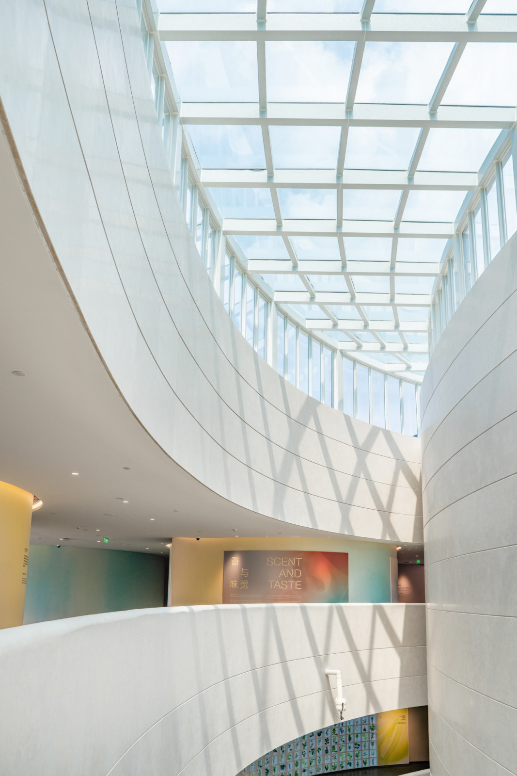 The museum’s sky-lit interior atrium, where curved white walls follow the cylindrical geometry of the building’s red-brick exterior