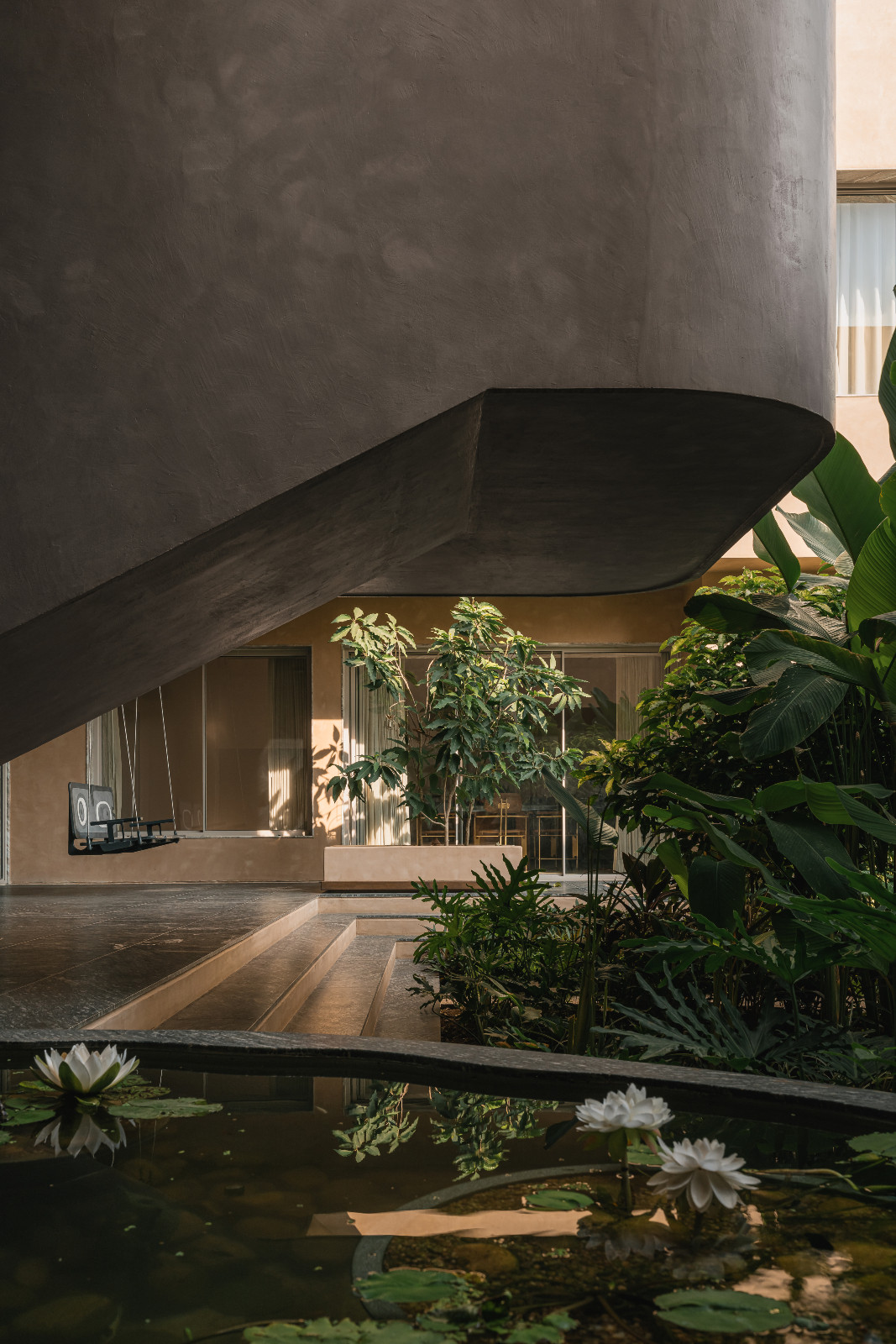 Lush greenery in a Navsari, India family home designed by Veeram Shah of Design Ni Dukaan
