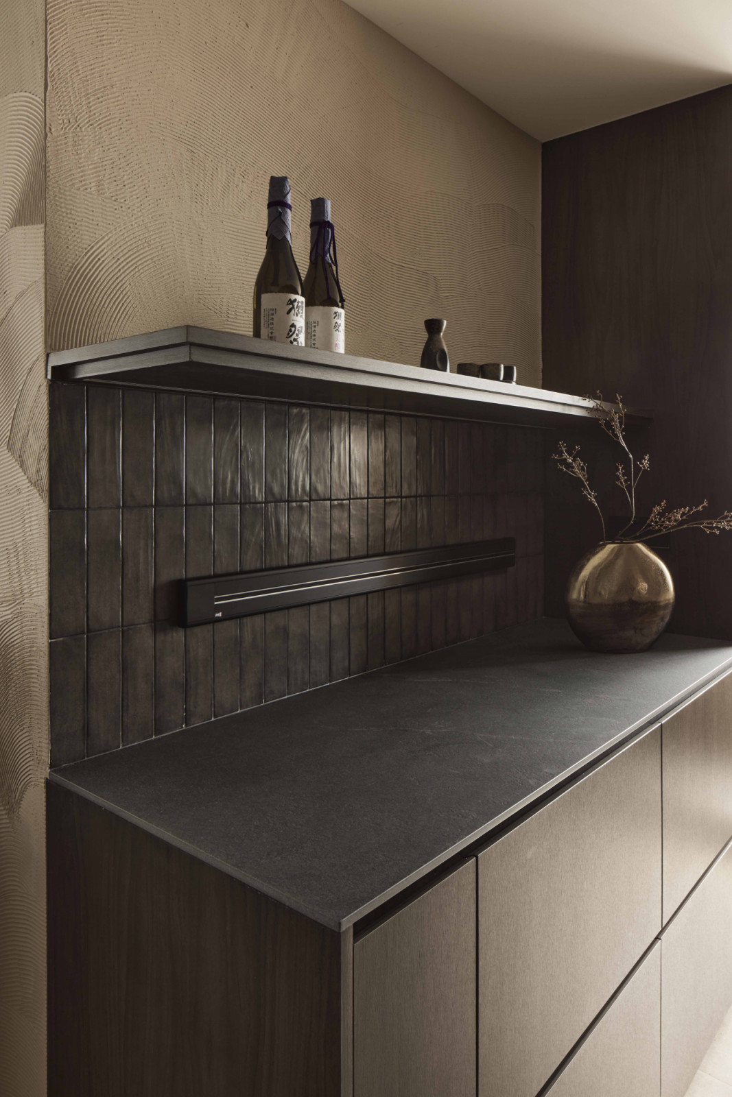 Hand-textured wave patterns inspired by Hokusai’s The Great Wave Off Kanagawa stretch across the kitchen
