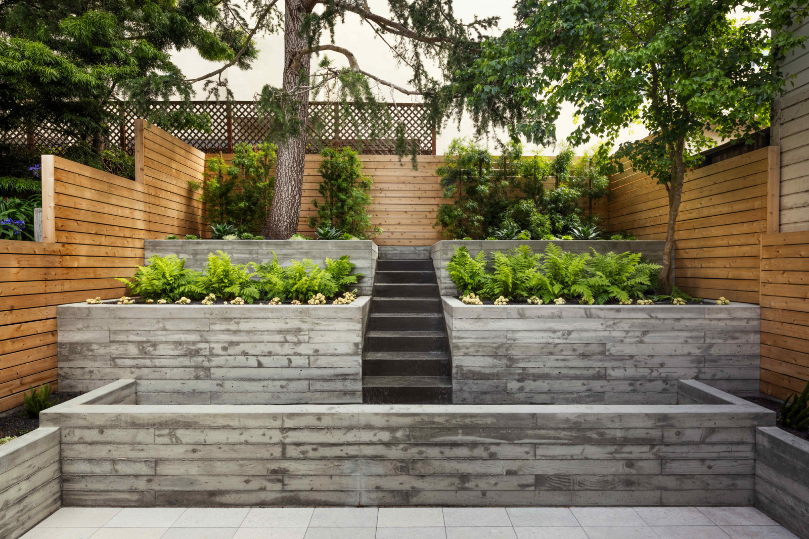The rear garden was revitalised with cast-in-place concrete planting tiers and a new timber fence set on fresh concrete foundations