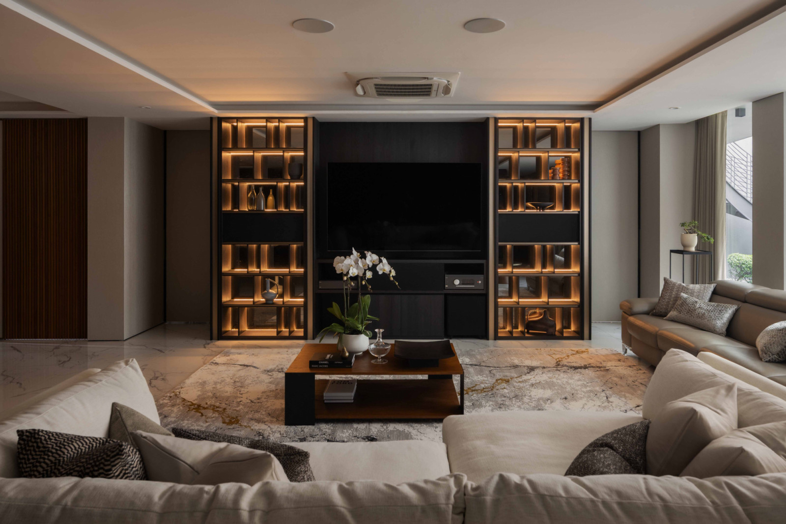 The basement entertainment lounge’s intimate and moody atmosphere offers an ideal backdrop to the clients’ extensive whiskey collection