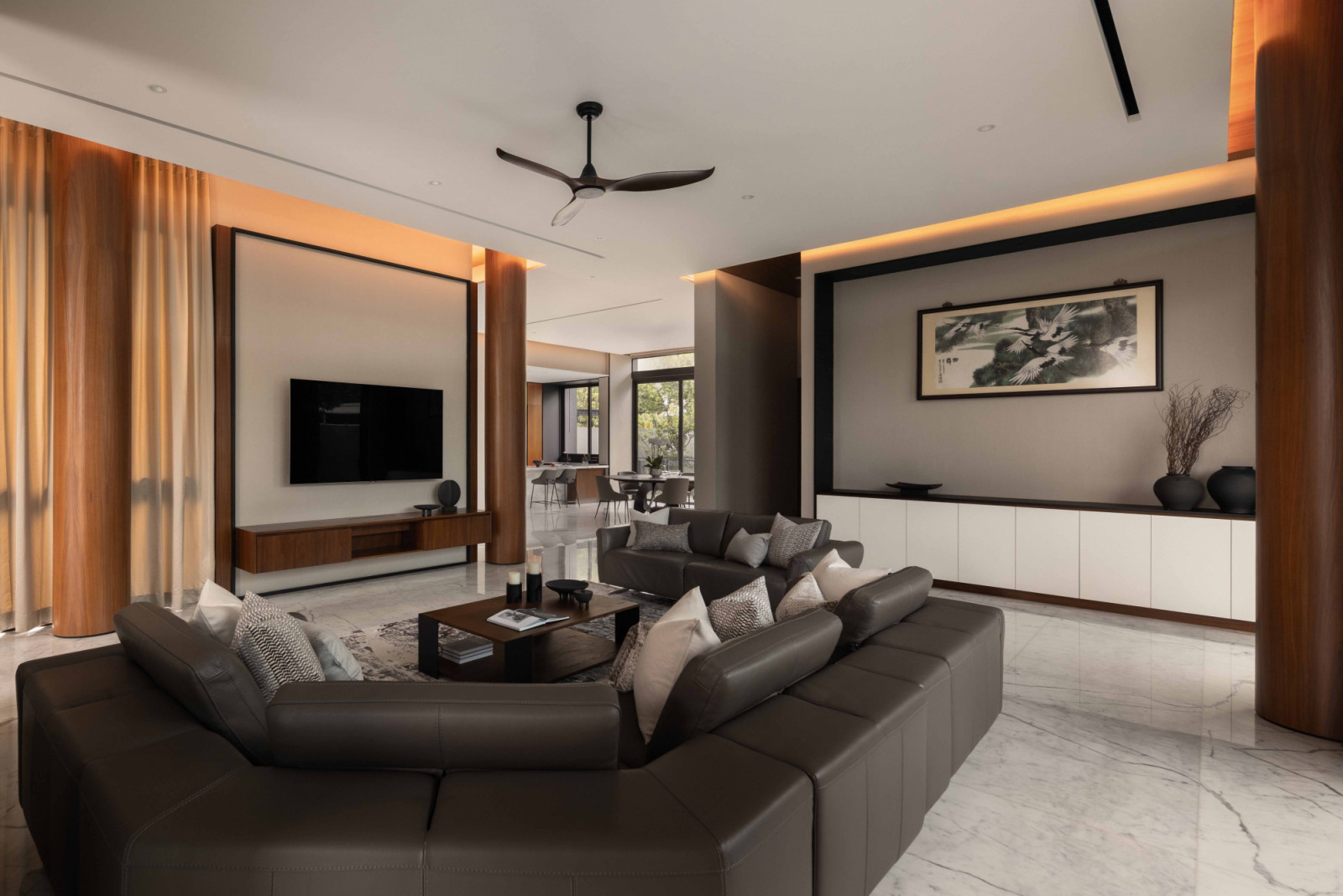 Another view of the living area, which sees structural columns clad in warm teakwood