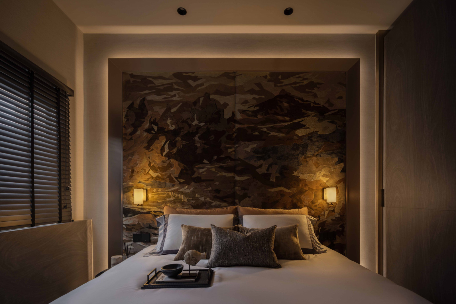 Brochier’s Vinicunca brocade fabric is used in two large panels to form a statement headboard backdrop in the master bedroom