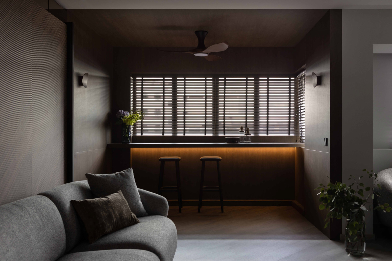 The home unexpectedly embraces shadow, texture, depth, and warmth to create a home with a strong sense of individuality