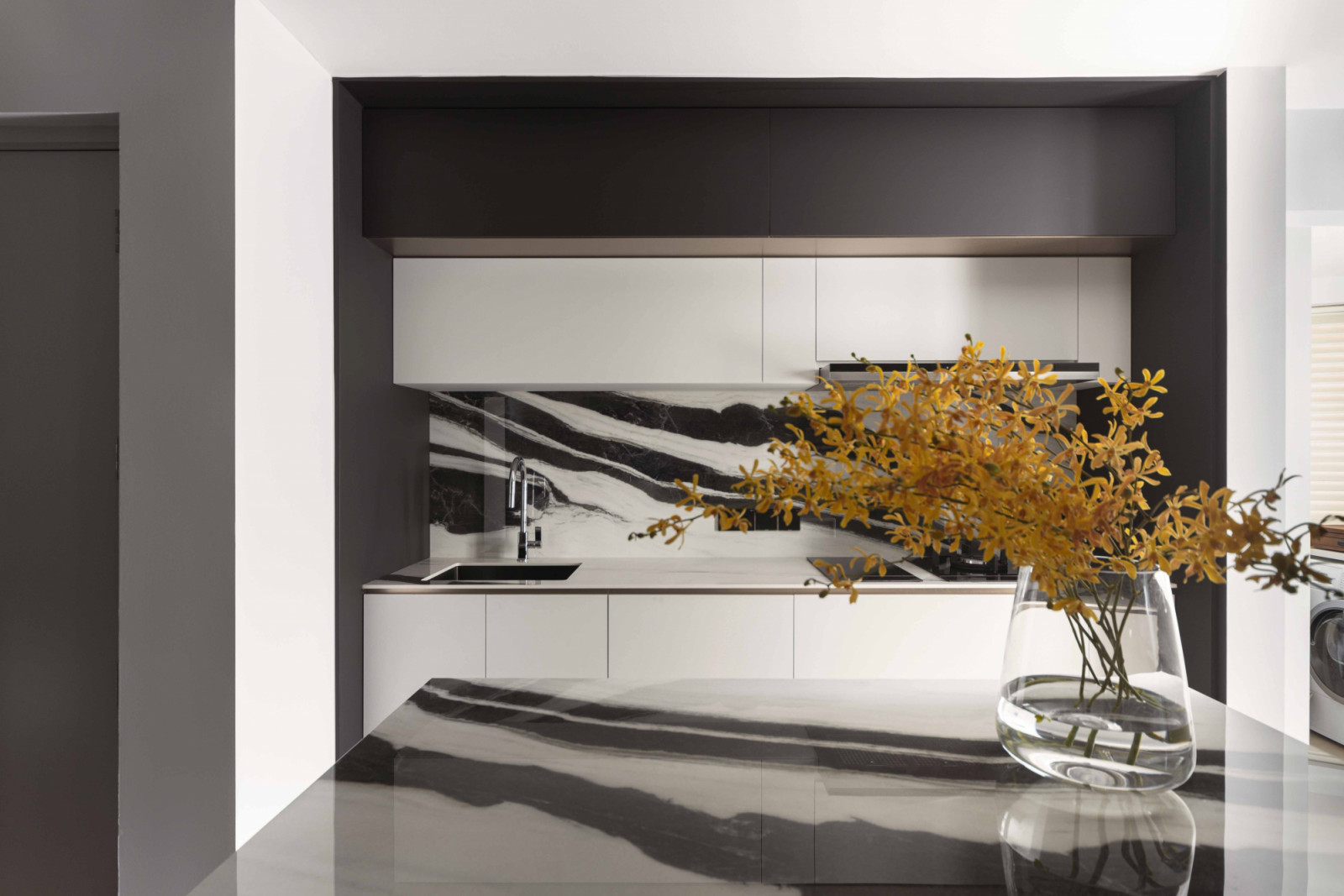 Panda White large-format porcelain slabs from Infinity Surfaces by KStone was used extensively in the newly enlarged kitchen