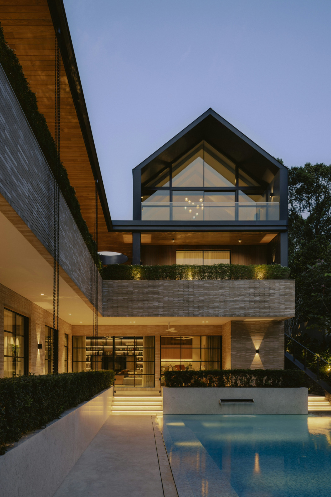 At dusk, the Binjai House showcases the timeless elegance of Classic’s French-style window and door systems